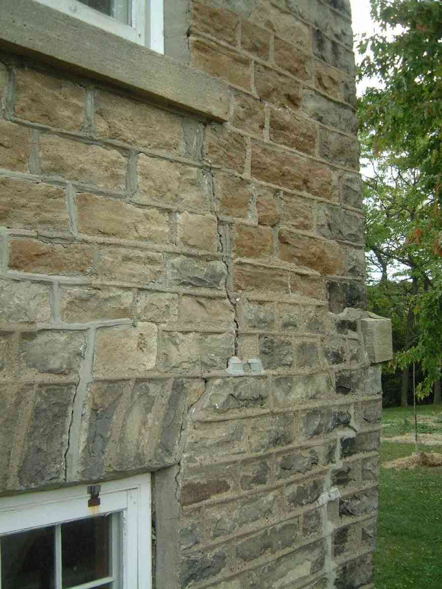 Exterior settlement crack on a house foundation wall